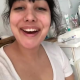 From under the toilet, a very cute girl shits with a hang and drop, plus pissing and product in the bowl. Filmed from a between the legs perspective. Vertical format video. Over a minute.